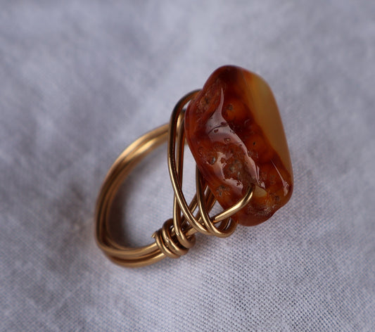 Wire Wrapped Ring: Gold and amber stone.